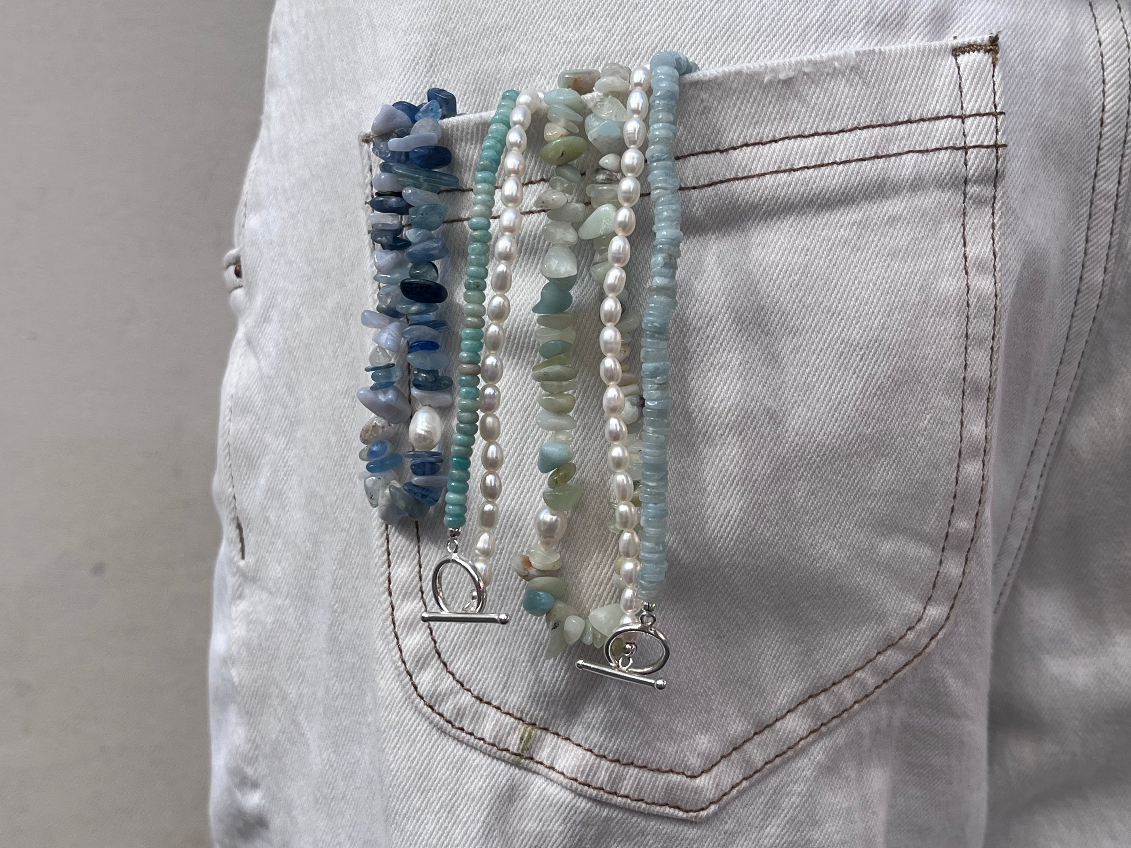 Stack of beaded bracelets on a pocket